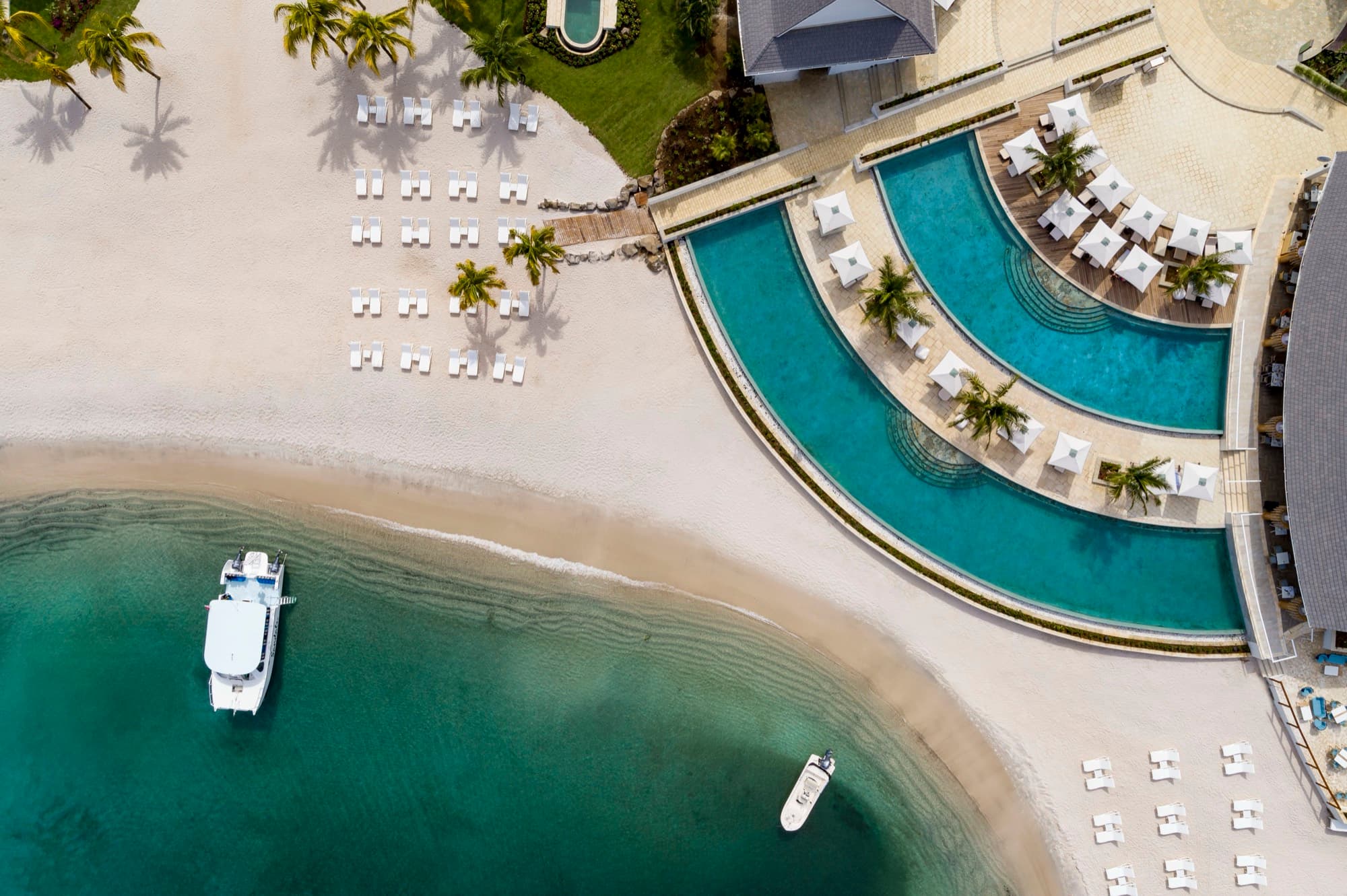 Beach, pool, and boat at Sandals Saint Vincent from above