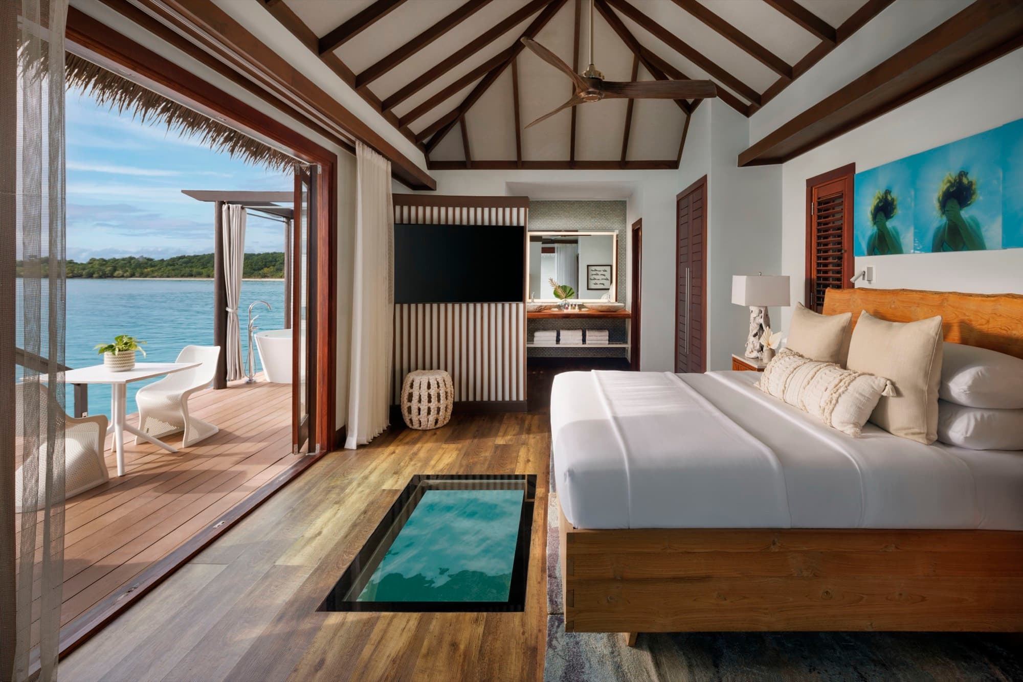 Overwater bungalow bedroom at Sandals South Coast